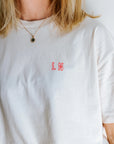 'IT COMES IN WAVES' T-SHIRT IN CREAM NEON