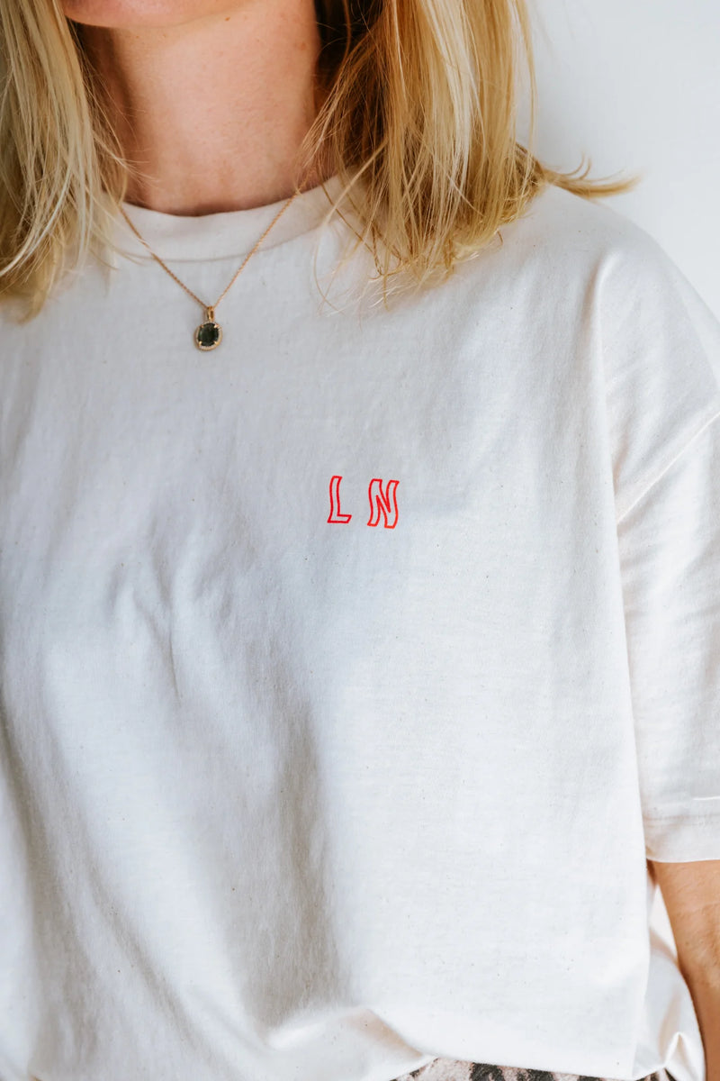 'IT COMES IN WAVES' T-SHIRT IN CREAM NEON